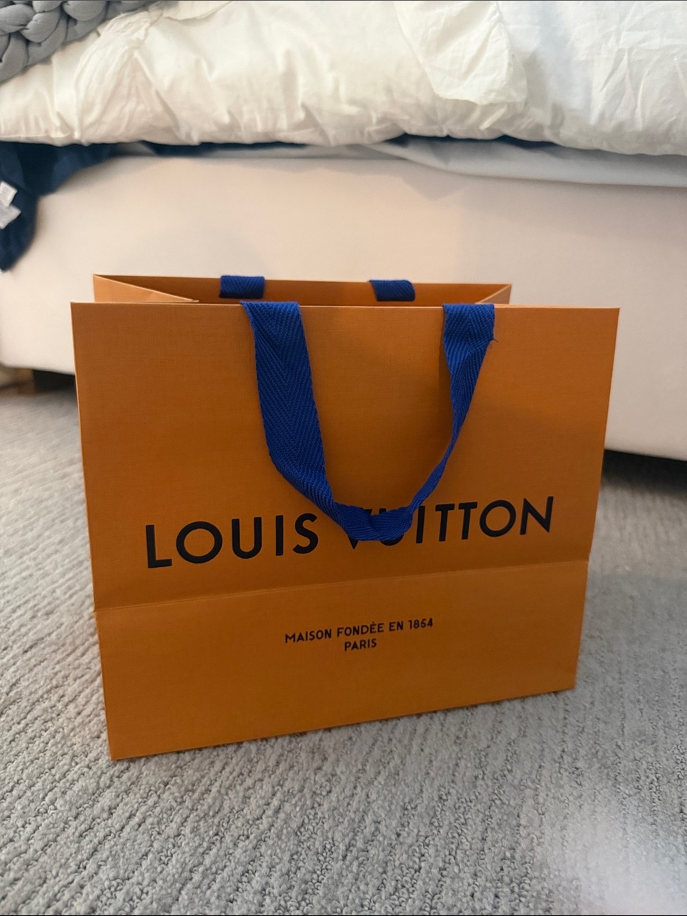 Louis Vuitton Orange Paper Bag with Blue Handles, two available but one bent
